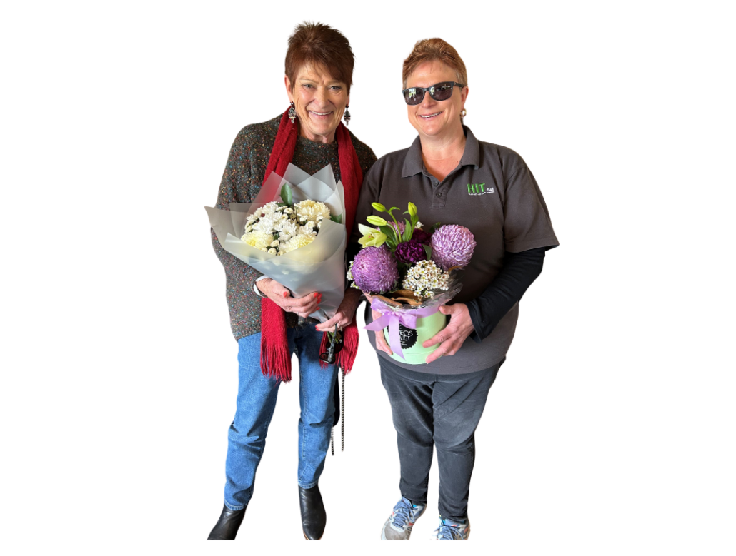 Two ladies pictured holding flowers